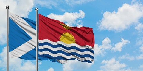 Scotland and Kiribati flag waving in the wind against white cloudy blue sky together. Diplomacy concept, international relations.
