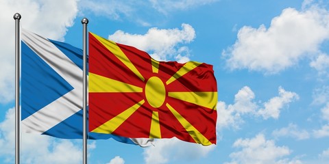 Scotland and Macedonia flag waving in the wind against white cloudy blue sky together. Diplomacy concept, international relations.