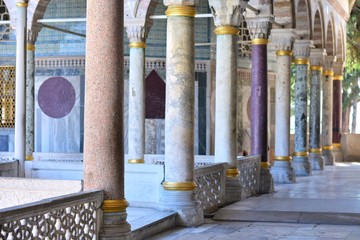 Beautiful colonnade of various breeds of natural stone in the Dolmabah&ccedil;e Palace. Colorful Natural stone columns with selective focus 