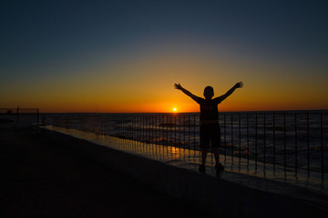 silhouette of a man jumping on the beach