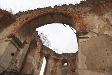 The picturesque ruins of an ancient cathedral. Ruined arch. The atmosphere of desolation