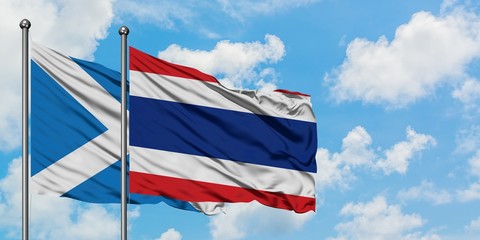 Scotland and Thailand flag waving in the wind against white cloudy blue sky together. Diplomacy concept, international relations.