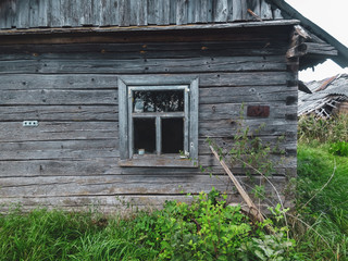 An old ruined house in Eastern Europe. The house of old logs of wood