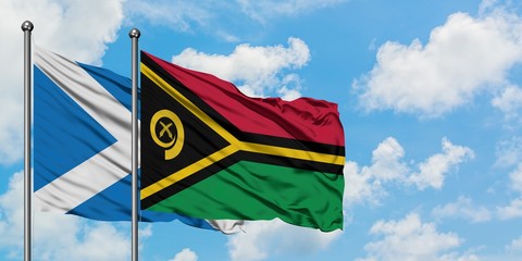 Scotland and Vanuatu flag waving in the wind against white cloudy blue sky together. Diplomacy concept, international relations.