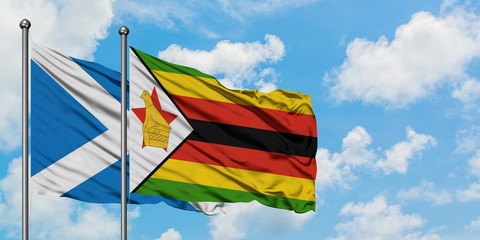 Scotland and Zimbabwe flag waving in the wind against white cloudy blue sky together. Diplomacy concept, international relations.