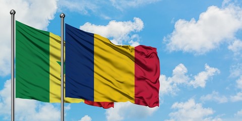 Senegal and Chad flag waving in the wind against white cloudy blue sky together. Diplomacy concept,...