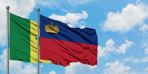 Senegal and Liechtenstein flag waving in the wind against white cloudy blue sky together. Diplomacy concept, international relations.