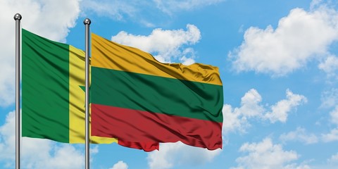 Senegal and Lithuania flag waving in the wind against white cloudy blue sky together. Diplomacy concept, international relations.