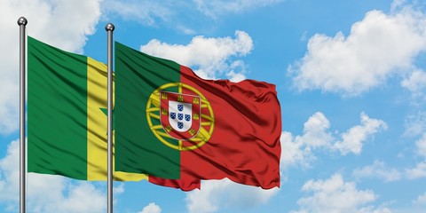 Senegal and Portugal flag waving in the wind against white cloudy blue sky together. Diplomacy concept, international relations.