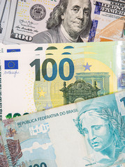 Hundred dollars, euros and brazilian reals bills