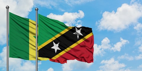 Senegal and Saint Kitts And Nevis flag waving in the wind against white cloudy blue sky together. Diplomacy concept, international relations.