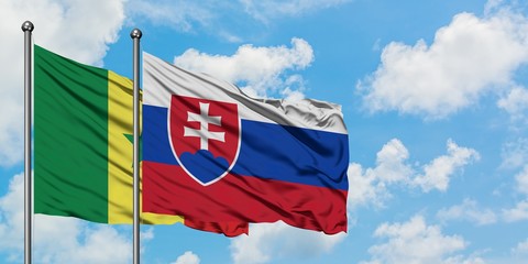 Senegal and Slovakia flag waving in the wind against white cloudy blue sky together. Diplomacy concept, international relations.