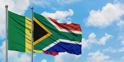 Senegal and South Africa flag waving in the wind against white cloudy blue sky together. Diplomacy concept, international relations.