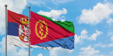 Serbia and Eritrea flag waving in the wind against white cloudy blue sky together. Diplomacy concept, international relations.