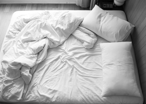 Unmade bed in bedroom. Black and white color tone. Object with copy space background.