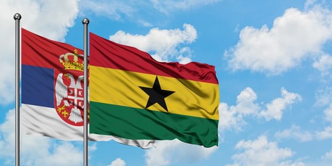 Serbia and Ghana flag waving in the wind against white cloudy blue sky together. Diplomacy concept, international relations.