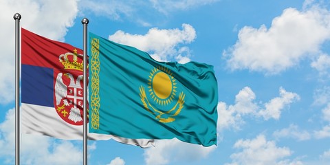 Serbia and Kazakhstan flag waving in the wind against white cloudy blue sky together. Diplomacy concept, international relations.