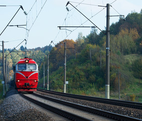 Train in the autumn. The train on the platform. The train pulls up to the platform. Public transport.Red train arriving to Vilnius, Lithuania. Travel concept. Travel