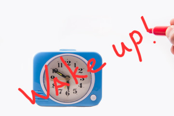 Alarm clock with the words wake up on the dial.
