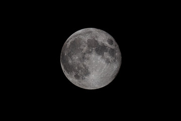 Full moon over dark black sky at night