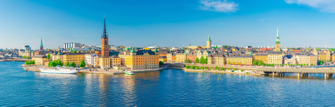 Aerial scenic panoramic view of Stockholm skyline with Old town Gamla Stan, typical Sweden houses, Riddarholmen island with gothic Church building, Lake Malaren, clear blue sky background, Sweden © Aliaksandr