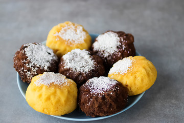 Useful buckwheat, rice and corn muffins with lemon and chocolate on a blue plate.