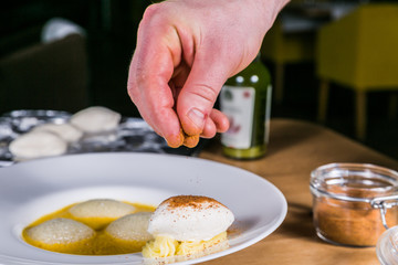 Close up hands of chef preparing food in the kitchen of a restaurant, cooking concept