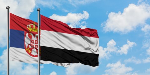 Serbia and Yemen flag waving in the wind against white cloudy blue sky together. Diplomacy concept, international relations.