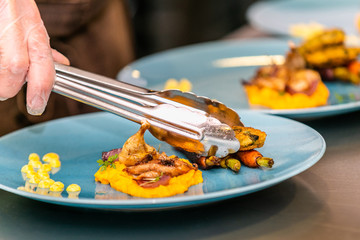 Close up hands of chef preparing food in the kitchen of a restaurant, cooking concept