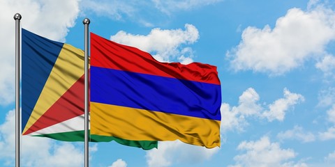 Seychelles and Armenia flag waving in the wind against white cloudy blue sky together. Diplomacy concept, international relations.
