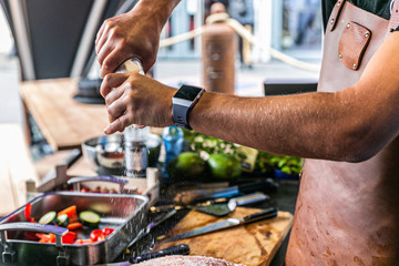 Close up hands of chef preparing food in the kitchen of a restaurant, cooking concept