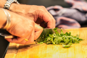 Close up hands of chef preparing food in the kitchen of a restaurant, cooking concept