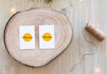 2 Vertical White Business Card on Wood Slice Top View Mockup