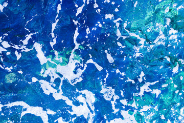Blue foamy surface of sea water top view