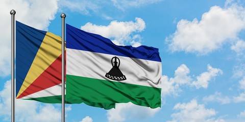 Seychelles and Lesotho flag waving in the wind against white cloudy blue sky together. Diplomacy concept, international relations.