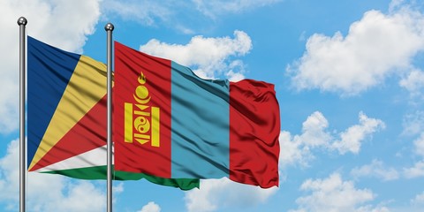 Seychelles and Mongolia flag waving in the wind against white cloudy blue sky together. Diplomacy concept, international relations.
