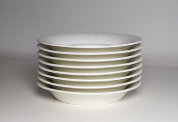 stack of empty plates isolated on white background