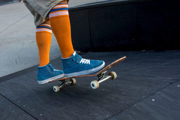 Close up of skateboarder with funny high socks riding skateboard in a skate park © Drpixel