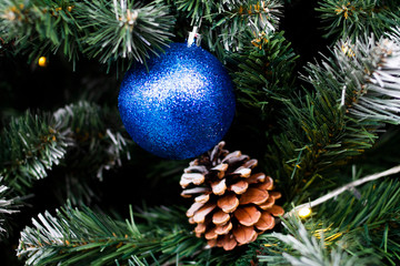 Christmas tree close-up with cones and blue balls