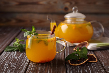 Hot sea buckthorn tea with mint, cinnamon and honey, a delicious preventive measure for colds, and to strengthen the immune system.