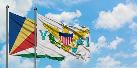 Seychelles and United States Virgin Islands flag waving in the wind against white cloudy blue sky together. Diplomacy concept, international relations.