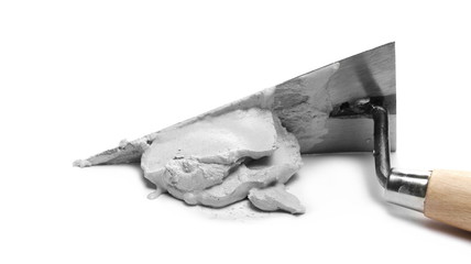 Cement mortar and metal trowel isolated on white background