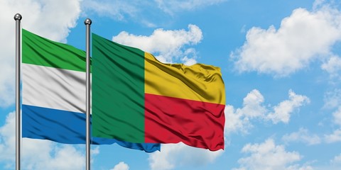 Sierra Leone and Benin flag waving in the wind against white cloudy blue sky together. Diplomacy concept, international relations.