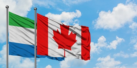 Sierra Leone and Canada flag waving in the wind against white cloudy blue sky together. Diplomacy concept, international relations.