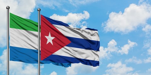 Sierra Leone and Cuba flag waving in the wind against white cloudy blue sky together. Diplomacy concept, international relations.