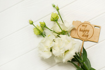 Fototapeta na wymiar eustoma flowers and wooden plate my happy holiday, birthday card