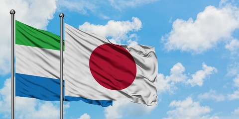 Sierra Leone and Japan flag waving in the wind against white cloudy blue sky together. Diplomacy concept, international relations.