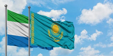 Sierra Leone and Kazakhstan flag waving in the wind against white cloudy blue sky together. Diplomacy concept, international relations.