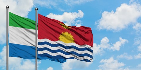 Sierra Leone and Kiribati flag waving in the wind against white cloudy blue sky together. Diplomacy concept, international relations.
