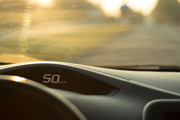 The dashboard of the car with a speed of 50 km / h on the speedometer; safe driving concept; speed...